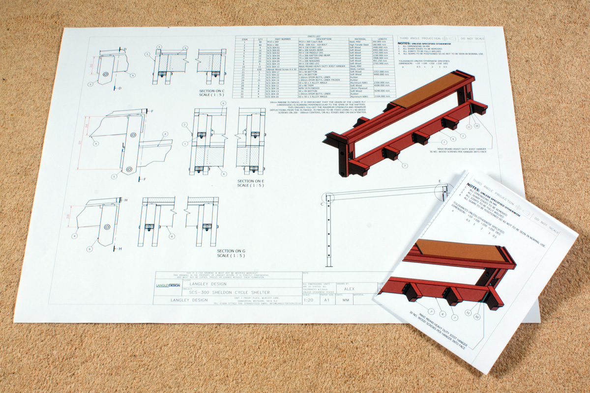 An A1 drawing flat waiting to be folded and one already folded ready to be stuffed into an envelope.